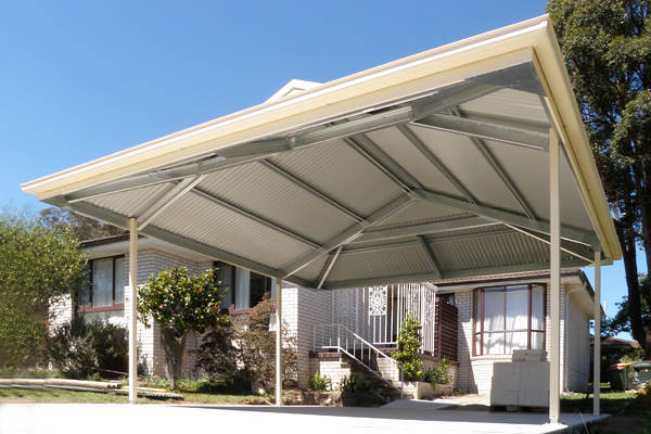 Underside of a residential Dutch gable carport roof with house in background