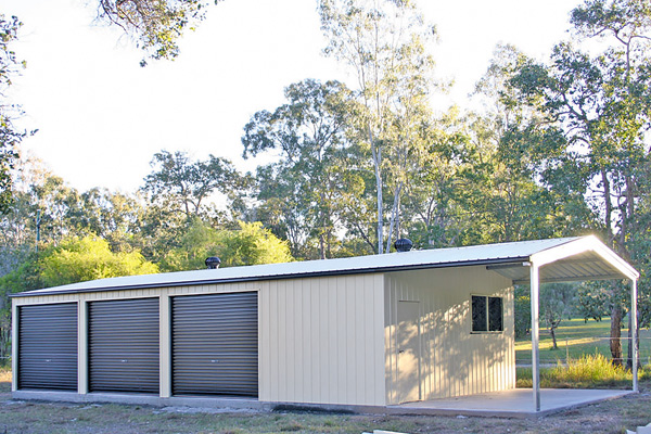 Garage with three roller doors on side and garaport plus personal access door and window on front